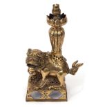 Chinese gilt bronze lamp, modelled as a temple dog on a rectangular base with lamp formed as a lotu