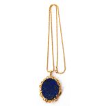 Lapis Lazuli pendant and chain, the large oval lapis set in a scroll and diamond highlighted