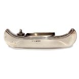 George V novelty table lighter/match holder in the form of a canoe with removable tray to centre,