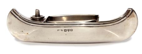 George V novelty table lighter/match holder in the form of a canoe with removable tray to centre,