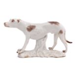 Small mid-18th century Meissen model of a hound on white base, with brown markings, 7cm long