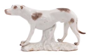 Small mid-18th century Meissen model of a hound on white base, with brown markings, 7cm long