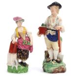 Pair of Derby figures of gardeners, mid 19th century, the figures standing on green rocky bases,