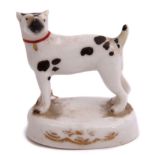 Mid-19th century English porcelain model of a dog on an oval base with brown markings, 5cm long