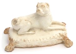 Bow porcelain figure of a pug dog seated on a tasselled cushion, 13cm long