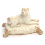 Bow porcelain figure of a pug dog seated on a tasselled cushion, 13cm long