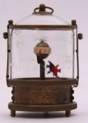 Unusual automaton clock of brass mounted cylindrical form, the glazed cover etched with fish, also