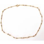 Antique yellow metal and seed pearl necklace, the design of cylindrical bars joined by circular