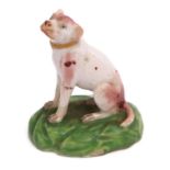 Late 18th century Derby model of a dog seated on its haunches on a green base, 6cm high