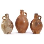 Collection of three stoneware flagons, the earliest probably 17th century with an orange peel