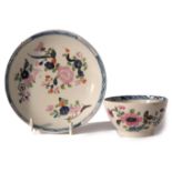 Lowestoft porcelain tea bowl and saucer, the underglaze blue design decorated over glaze with