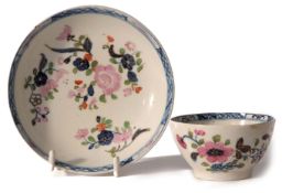 Lowestoft porcelain tea bowl and saucer, the underglaze blue design decorated over glaze with