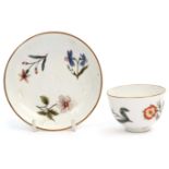 Mid-18th century Meissen tea bowl and saucer decorated with scattered Holzschnittblumen, the
