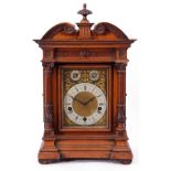 Late 19th century large German oak cased bracket clock, the gilt metal dial with black Roman