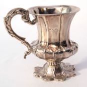 William IV christening mug of campana form with leaf moulded body and cast foot, hollow scrolled