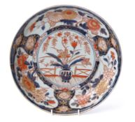 Large 19th century Japanese Imari charger, the centre decorated with a vase of flowers in iron red
