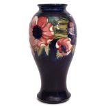Large Moorcroft vase, the baluster body decorated with a tube lined design of anemones on a blue