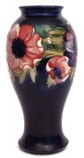 Large Moorcroft vase, the baluster body decorated with a tube lined design of anemones on a blue