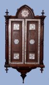 Moorish hardwood wall cabinet inlaid with mother of pearl detail throughout and applied with ring