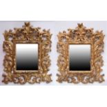 Pair of good quality reproduction gilded wall mirrors with floral scroll surrounds, 94cm high x 80cm