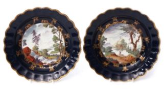 Two 18th century Worcester plates circa 1770, the gros bleu ground decorated to the centre with