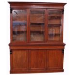 Victorian mahogany library bookcase of small proportions, moulded cornice over three glazed doors