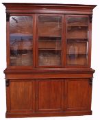 Victorian mahogany library bookcase of small proportions, moulded cornice over three glazed doors