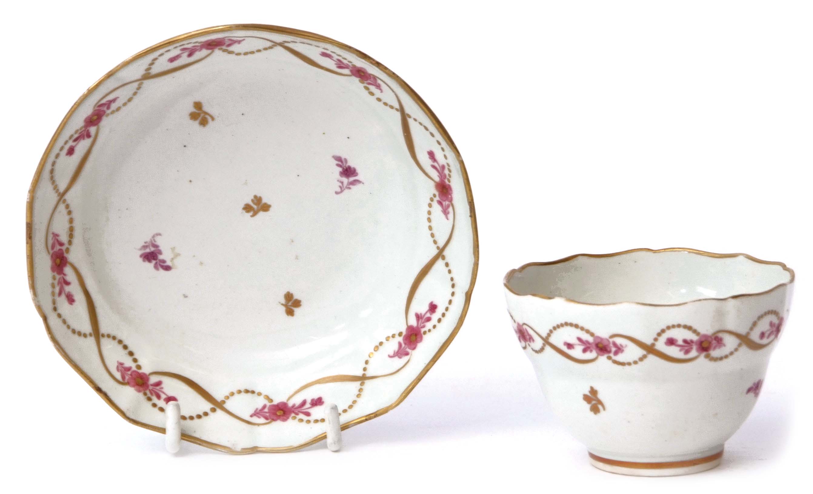 Lowestoft porcelain ogee shaped tea bowl and saucer circa 1790, with gilt and puce design, the