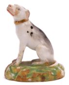 Early Derby porcelain model of a dog seated on a green base, 7cm high