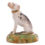 Early Derby porcelain model of a dog seated on a green base, 7cm high
