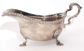 Elizabeth II sauce boat in George II style of heavy gauge and having a gadrooned rim, leaf capped