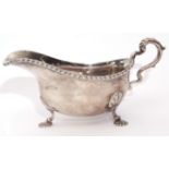 Elizabeth II sauce boat in George II style of heavy gauge and having a gadrooned rim, leaf capped