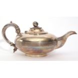 Victorian tea pot of compressed circular form with reeded body, looped leaf capped hollow handle,