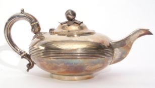 Victorian tea pot of compressed circular form with reeded body, looped leaf capped hollow handle,