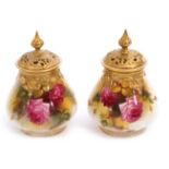 Pair of Royal Worcester pot pourri vases with gilt reticulated covers, painted with roses, one