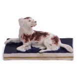 Staffordshire or possibly Samuel Alcock model of a spaniel with brown markings, seated on a