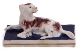 Staffordshire or possibly Samuel Alcock model of a spaniel with brown markings, seated on a