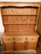 MODERN PINE FRAMED DRESSER, THE TOP FITTED WITH TWO FIXED SHELVES AND PANELLED BACK, THE BASE WITH