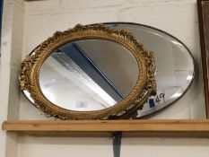 GILT RESIN CIRCULAR WALL MIRROR TOGETHER WITH AN OVAL FRAMED WALL MIRROR WITH BEVELLED GLASS