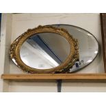 GILT RESIN CIRCULAR WALL MIRROR TOGETHER WITH AN OVAL FRAMED WALL MIRROR WITH BEVELLED GLASS