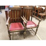 TWO EARLY 20TH CENTURY OAK FRAMED ARMCHAIRS WITH RED REXINE DROP IN SEATS