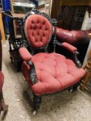 AESTHETIC PERIOD EBONISED ARMCHAIR WITH RED UPHOLSTERY WITH BUTTON DETAIL AND HEAVILY CARVED