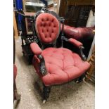 AESTHETIC PERIOD EBONISED ARMCHAIR WITH RED UPHOLSTERY WITH BUTTON DETAIL AND HEAVILY CARVED