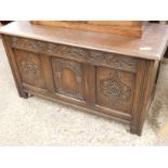 EARLY 20TH CENTURY OAK FRAMED COFFER WITH THREE PANELLED AND CARVED FRONT AND LIFT UP LID