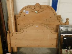 WAXED PINE DOUBLE BED WITH CARVED HEADBOARD AND SIDE RAILS