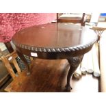 MAHOGANY CIRCULAR COFFEE TABLE RAISED ON FOUR CLAW AND BALL FEET