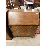 OAK FRAMED CHEQUERED INLAID BUREAU WITH DROP FRONT WITH FOUR FULL WIDTH DRAWERS RAISED ON BRACKET