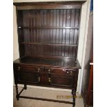 OAK FRAMED DRESSER, THE TOP FITTED WITH TWO FIXED SHELVES AND PANELLED BACK, THE BASE WITH TWO