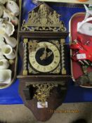 WALL CLOCK WITH SILVERED DIAL AND CARVED METAL FIGURES ABOVE