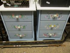 PAIR OF BLUE AND WHITE PAINTED THREE DRAWER BEDSIDE CHESTS WITH FLORAL DETAILING